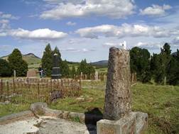 A cemetery with a fence and a stone pillar

AI-generated content may be incorrect.