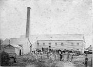 A group of people standing outside a factory

AI-generated content may be incorrect.